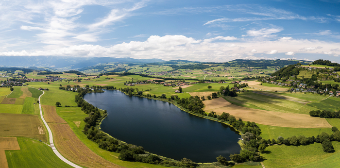 Aerial panorama image of Gerzensee lake in Bern Oberland, Switzerland