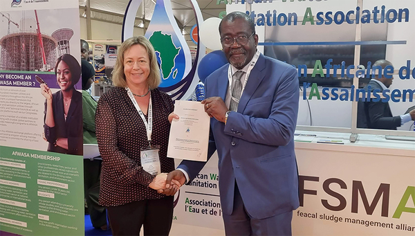 Linda Strande and Sylvain Usher, Executive Director of AfWASA, with the Memorandum of Understanding (Photographer: Unknown)