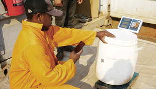 An employee of a toilet supplier scans the QR code of the collected containers. (LooWatt)